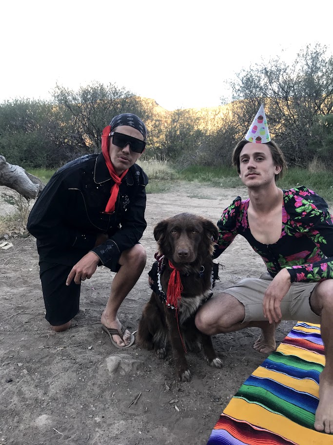A picture of Wade and Elliot leaned over with Pancho